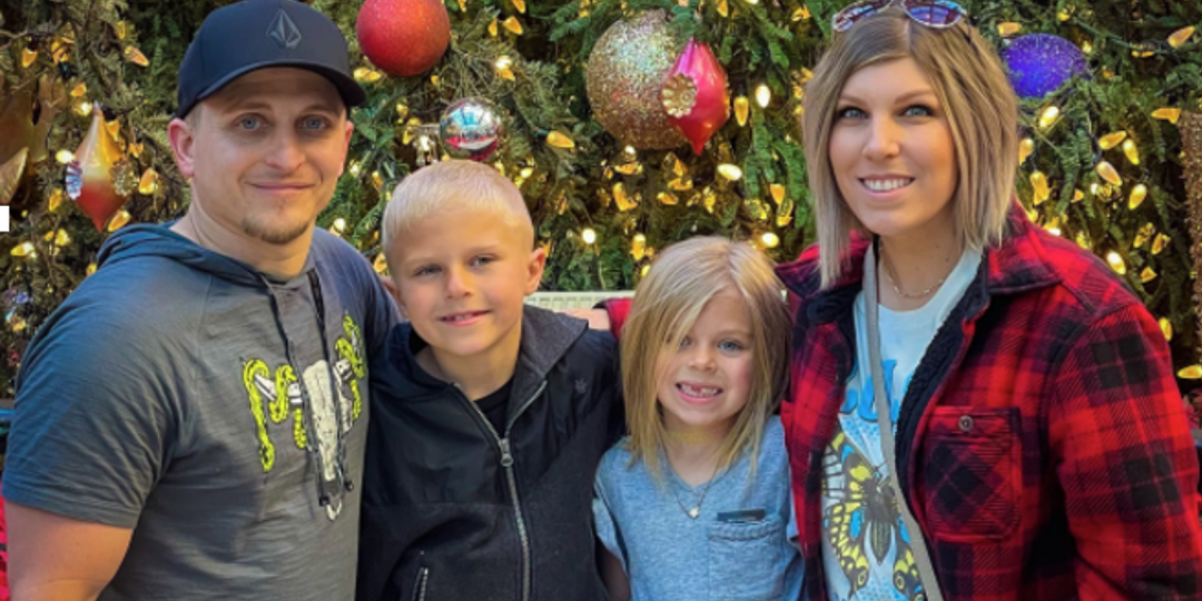 family in front of christmas tree