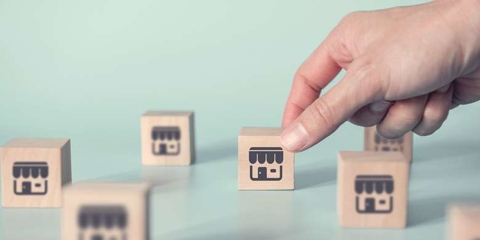 Person with building blocks of businesses