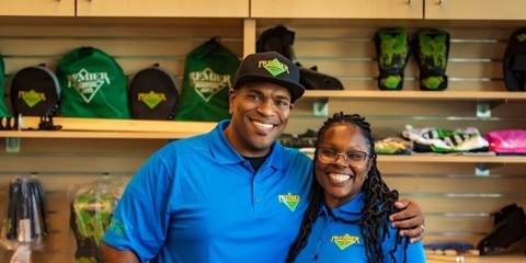 Two franchise owners standing at check-in desk