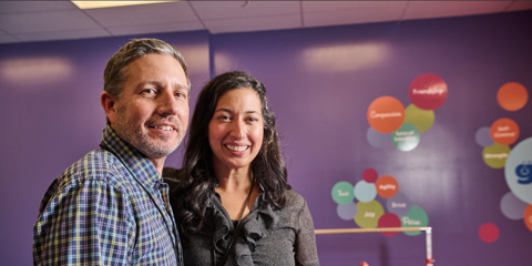 man and woman standing inside kids gym