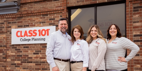 individuals standing outside with building sign