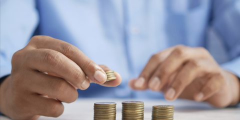 person stacking coins