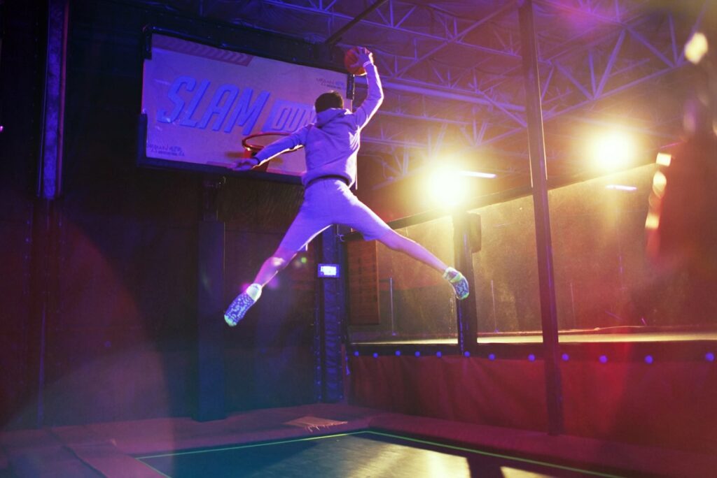 A kid making a slam dunk at an Urban Air franchise